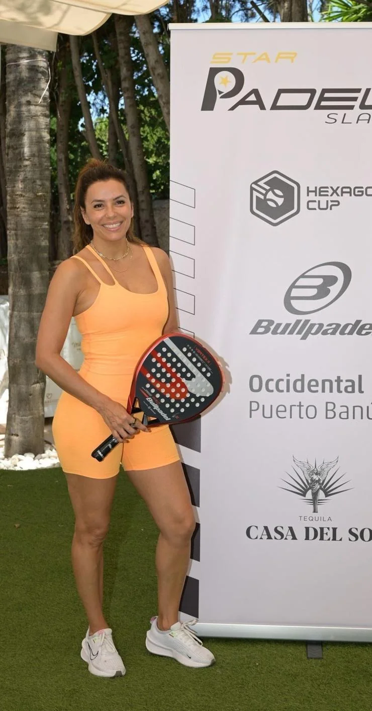 Eva Longoria, 49 playing Tennis in an orange spandex romper picture 2 of 6