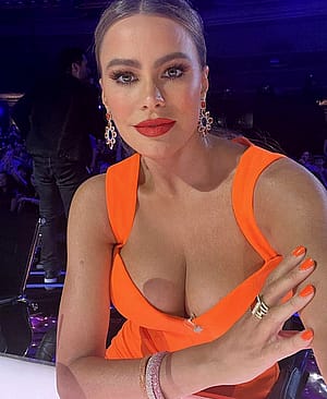 Sofia Vergara, 50 showing off her Cleavage in an orange Dress'